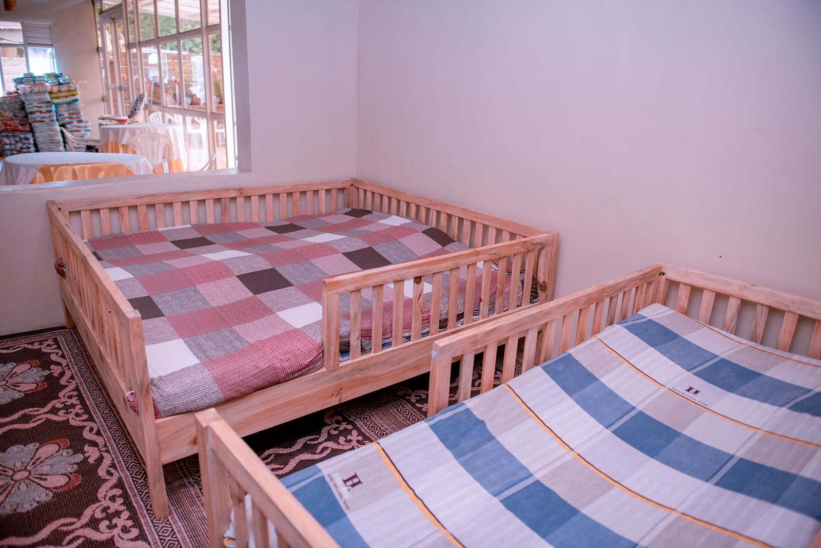 Wooden dormitory beds with fresh mattresses at the center