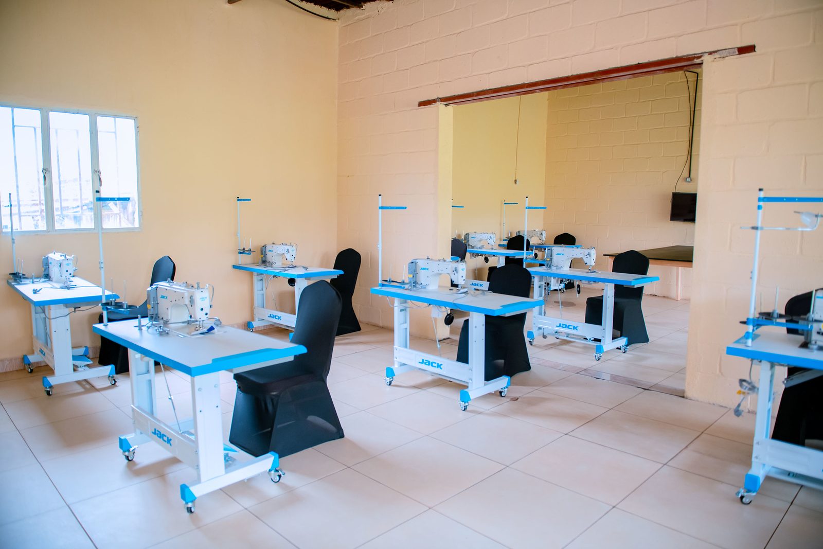 The tailoring training room with rows of sewing machines